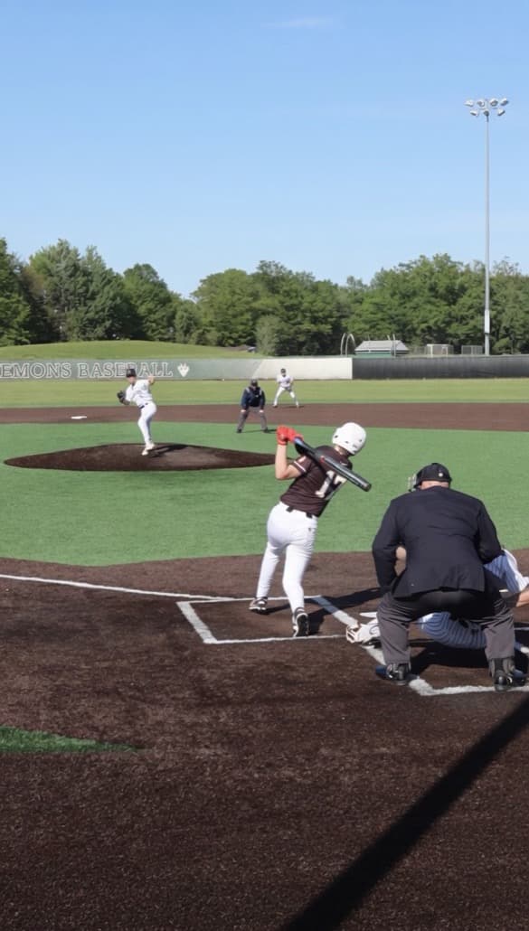Connor Schneider batting in game action